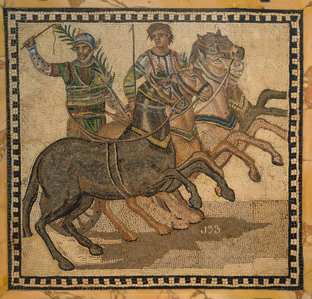 Roman mosaic of a victorious charioteer with a palm branch and his four-horse team