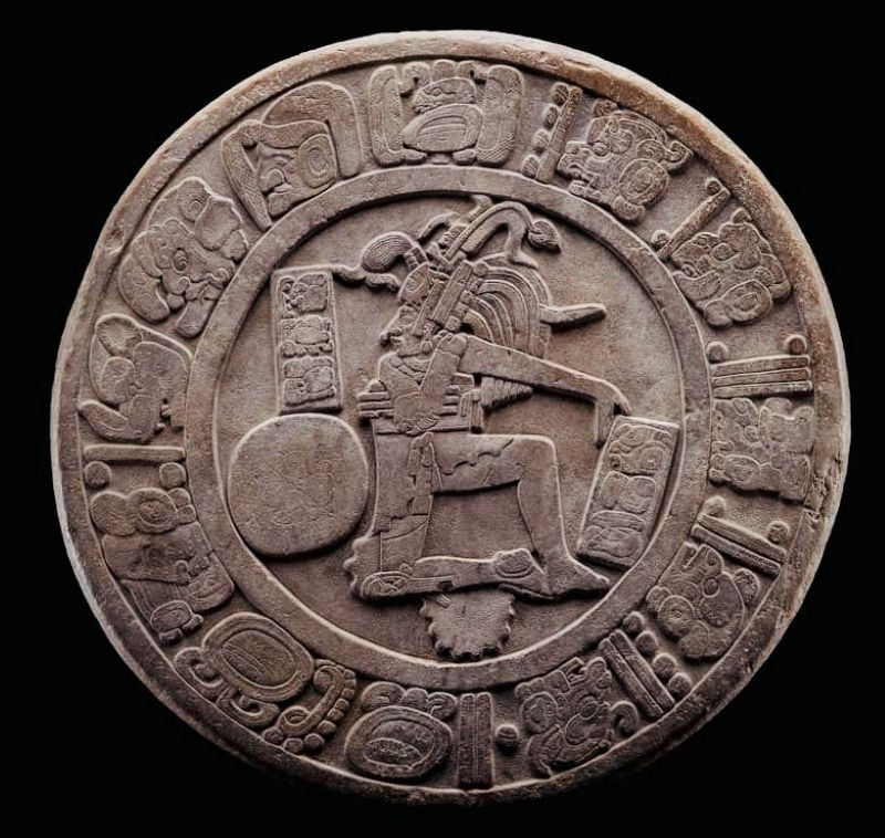 Carved stone ballcourt marker showing a Maya ballplayer, ringed by hieroglyphs