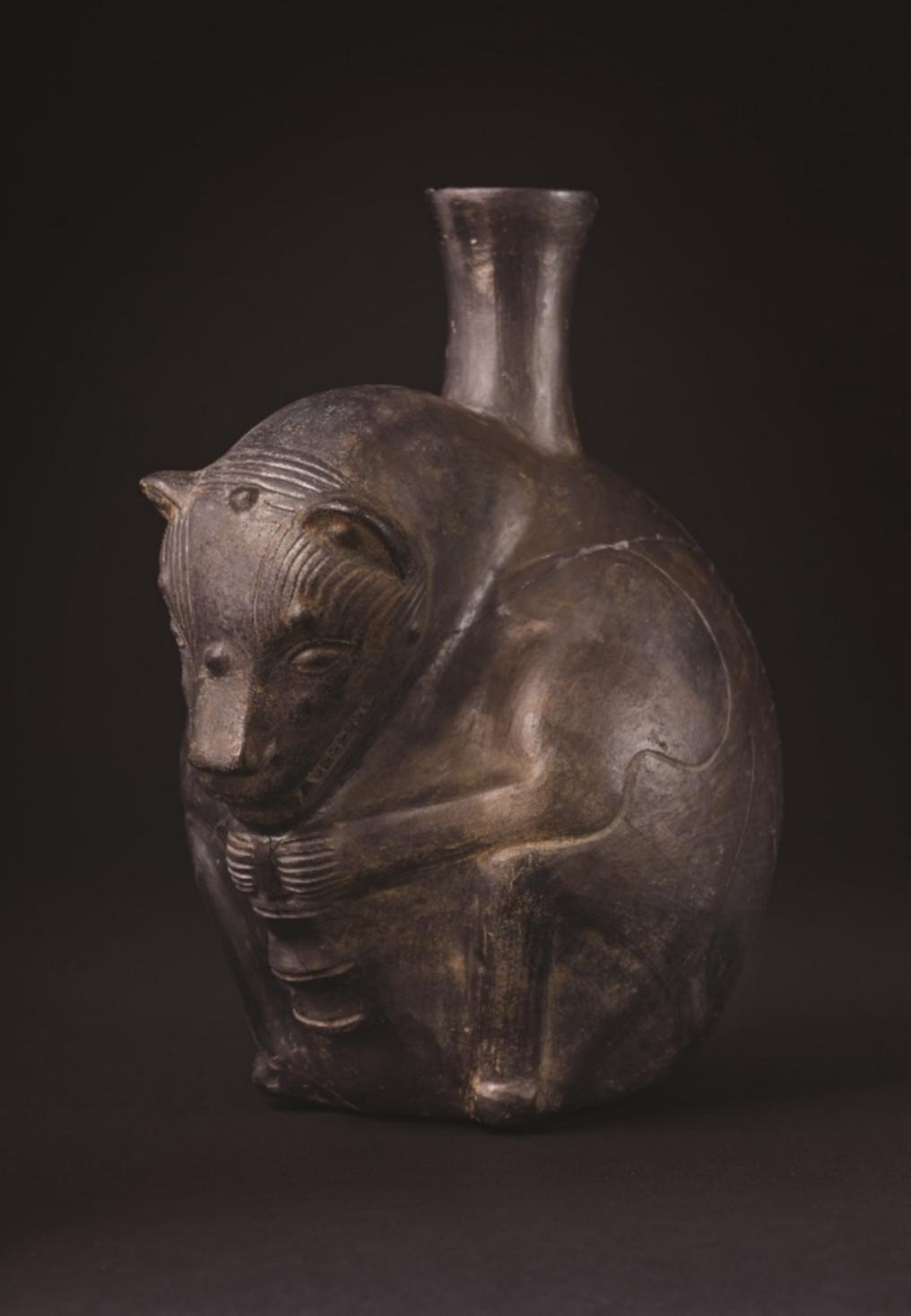 Blackware stirrup-spout vessel in the form of a seated feline, Wari culture, Castillo de Huarmey, Peru